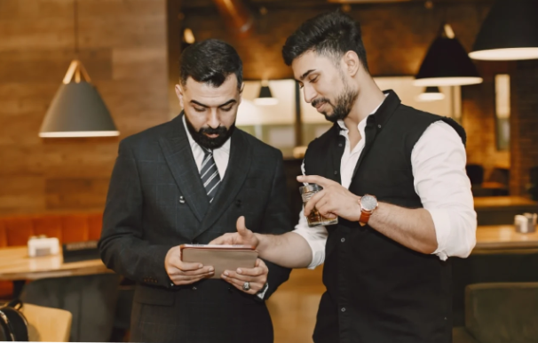 Two people discussing tablet - CaPOS