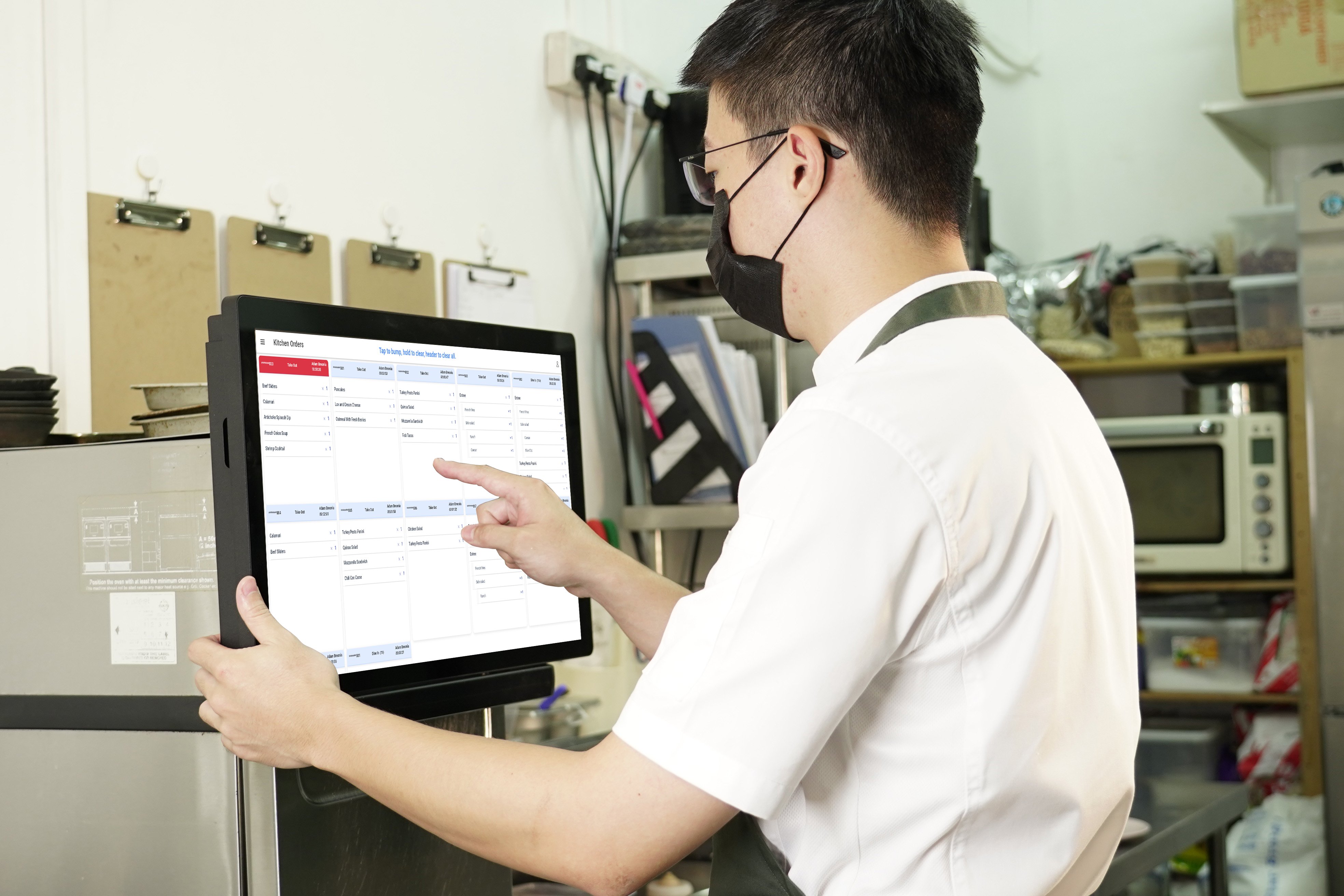 Kitchen staff using CaPOS Kitchen Display System