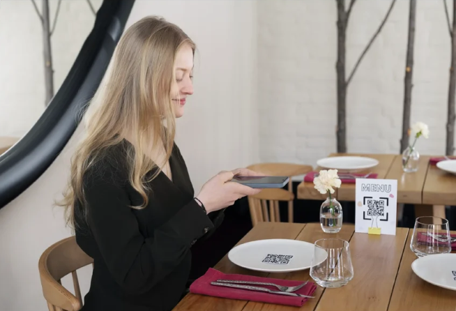 Guest using mobile to order at restaurant table