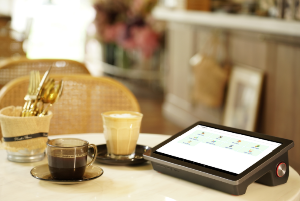 Guest using CaPOS reservation tablet at a cafe table